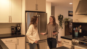 Two women talking in a kitchen