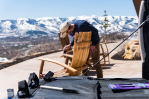 Man staining wood chair